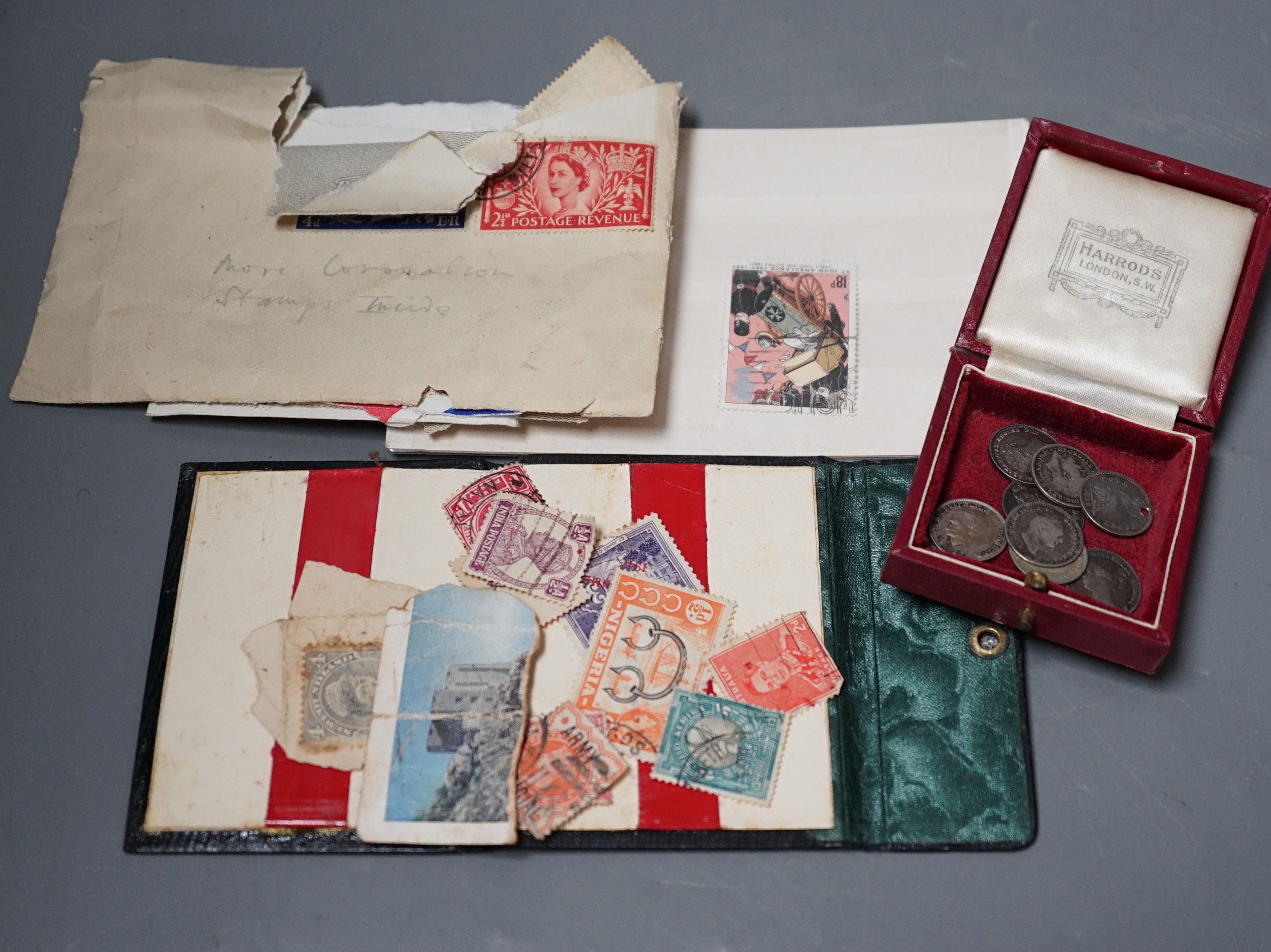 Nine silver four, three and one pence coins George III, Victoria and George V and a small quantity of stamps.